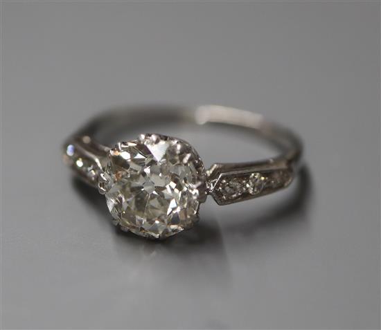 A mid 20th century white metal and single stone diamond ring, with diamond set shoulders, size K/L.